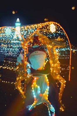 An artist in festive costume performing at a holiday event filled with joyful guests.