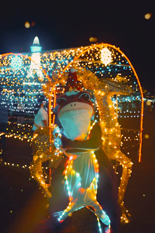 A holiday character spreading cheer with colorful decorations in the background.