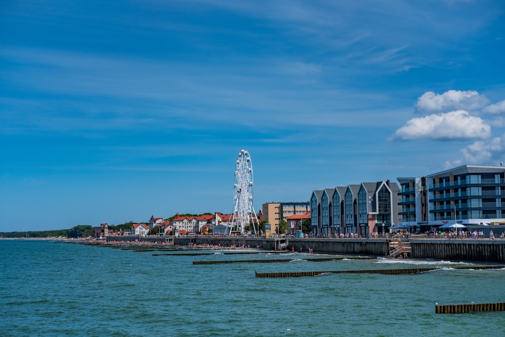 a view of a pier with a ferris wheel in the background