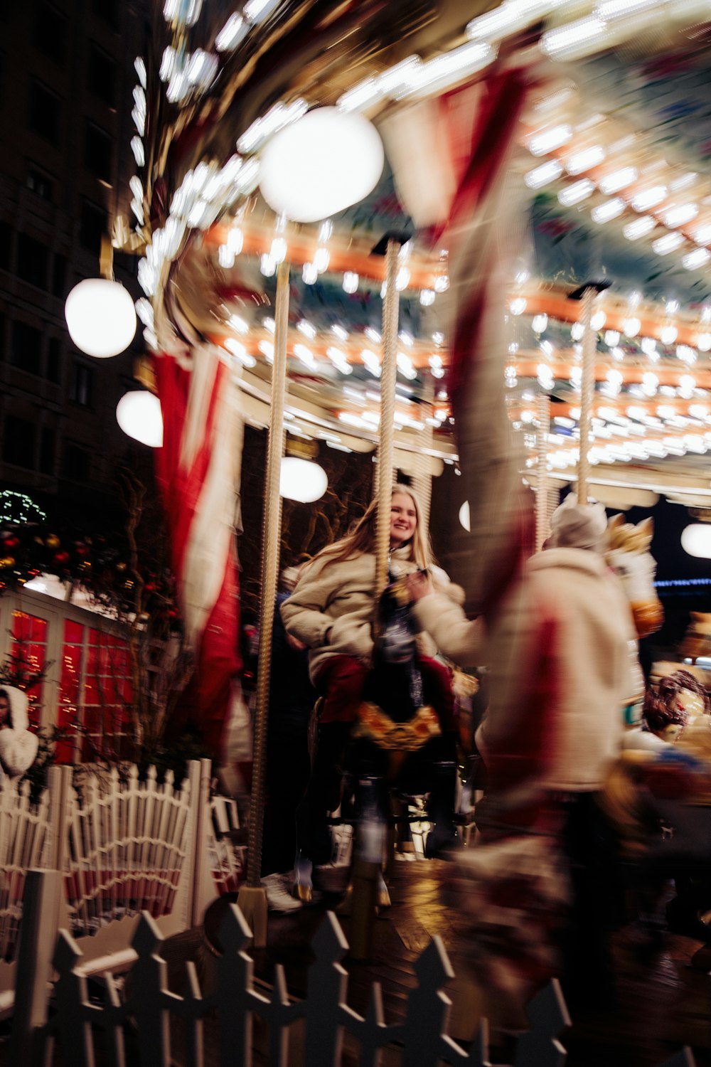 a blurry photo of a woman riding a merry go round