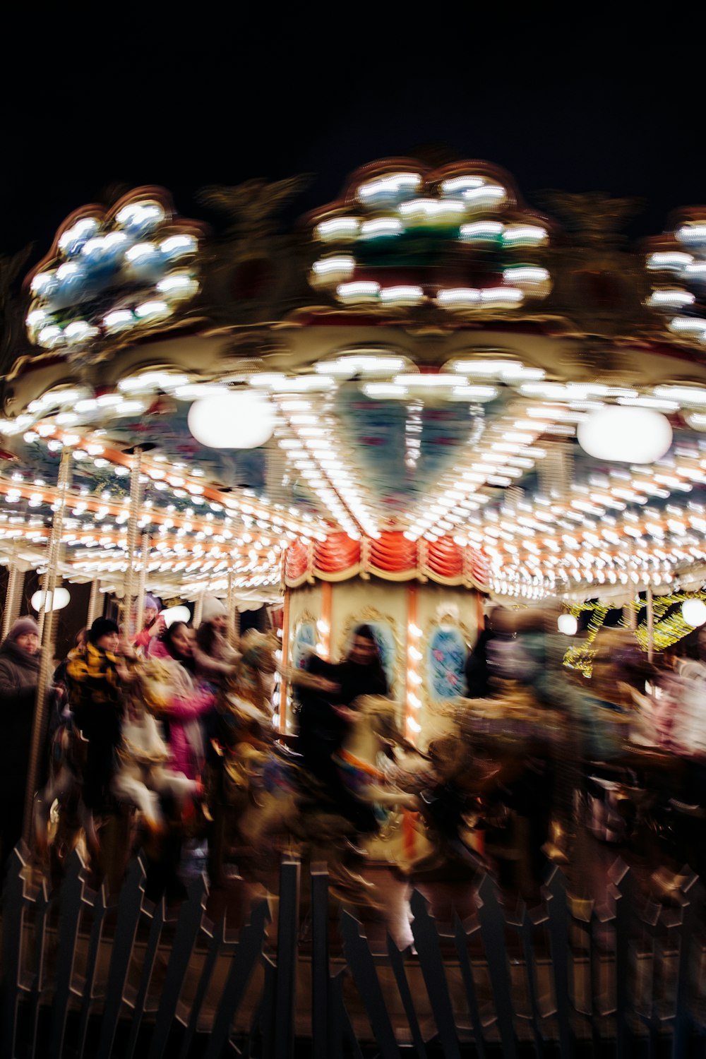 a merry go round at night with people on it