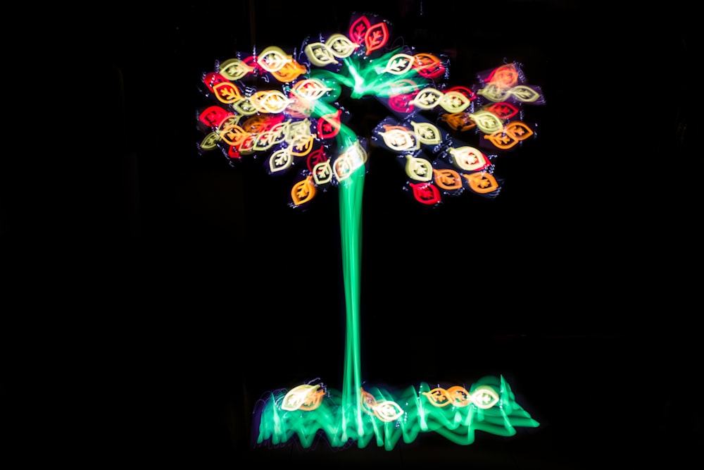 a colorful light up flower on a black background