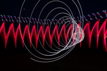 a long exposure photo of red and white lights