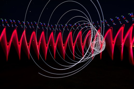a long exposure photo of red and white lights