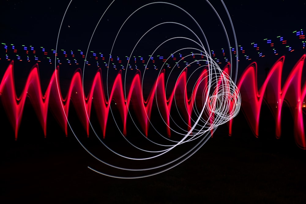 a long exposure photo of red and white lights