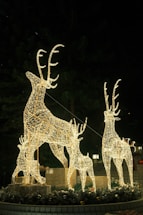 A cozy workshop with colorful LED Christmas reindeer figures glowing warmly in the evening.