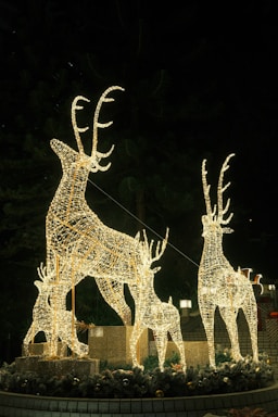 A cozy workshop with colorful LED Christmas reindeer figures glowing warmly in the evening.