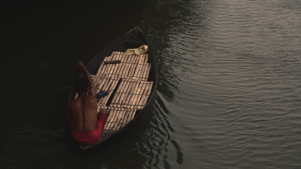 a person in a small boat on a body of water