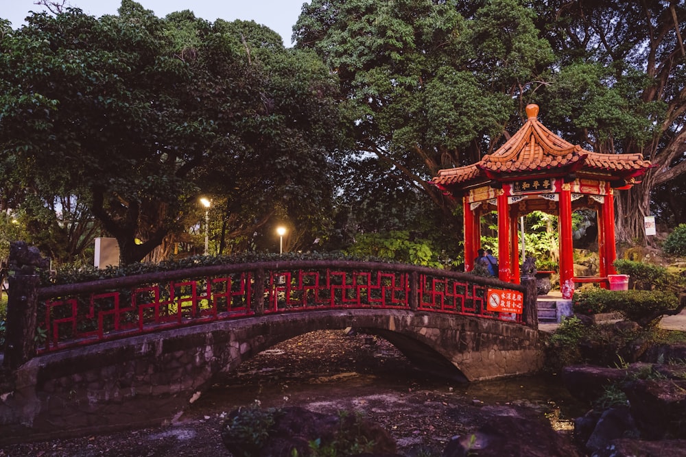 a small bridge over a pond in a park