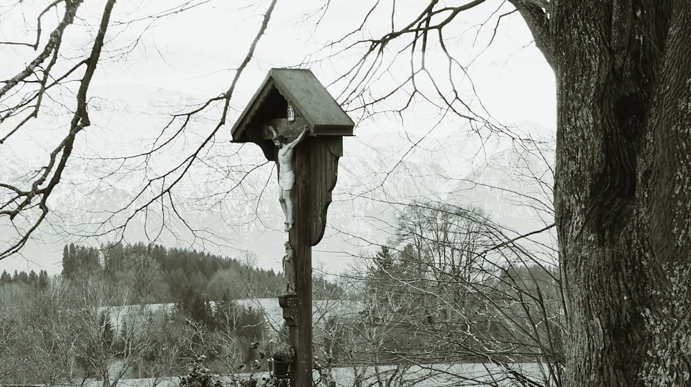 a black and white photo of a bird house