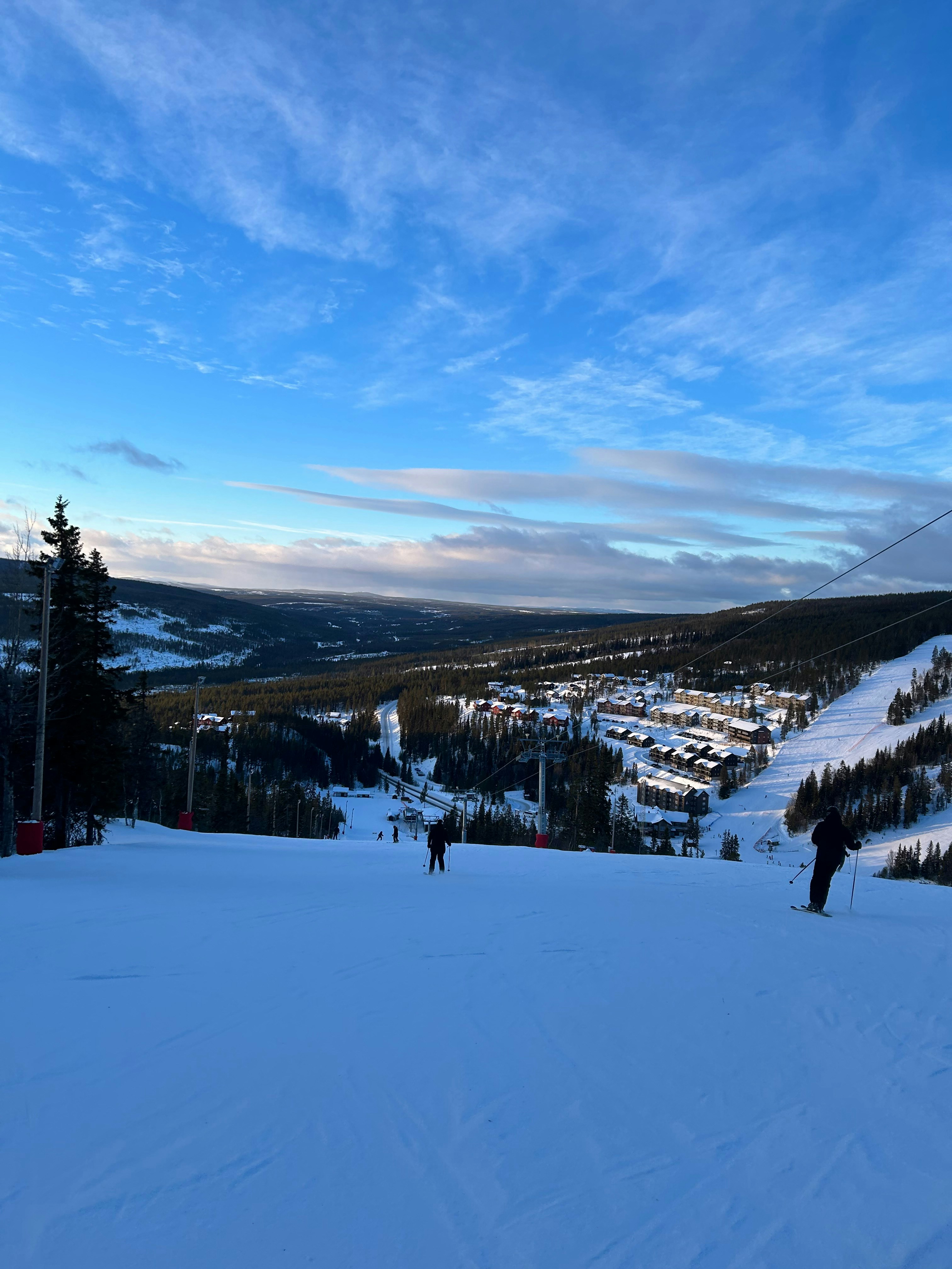 Snow-covered ski chalet at Northstar with blue sky and groomed ski slopes