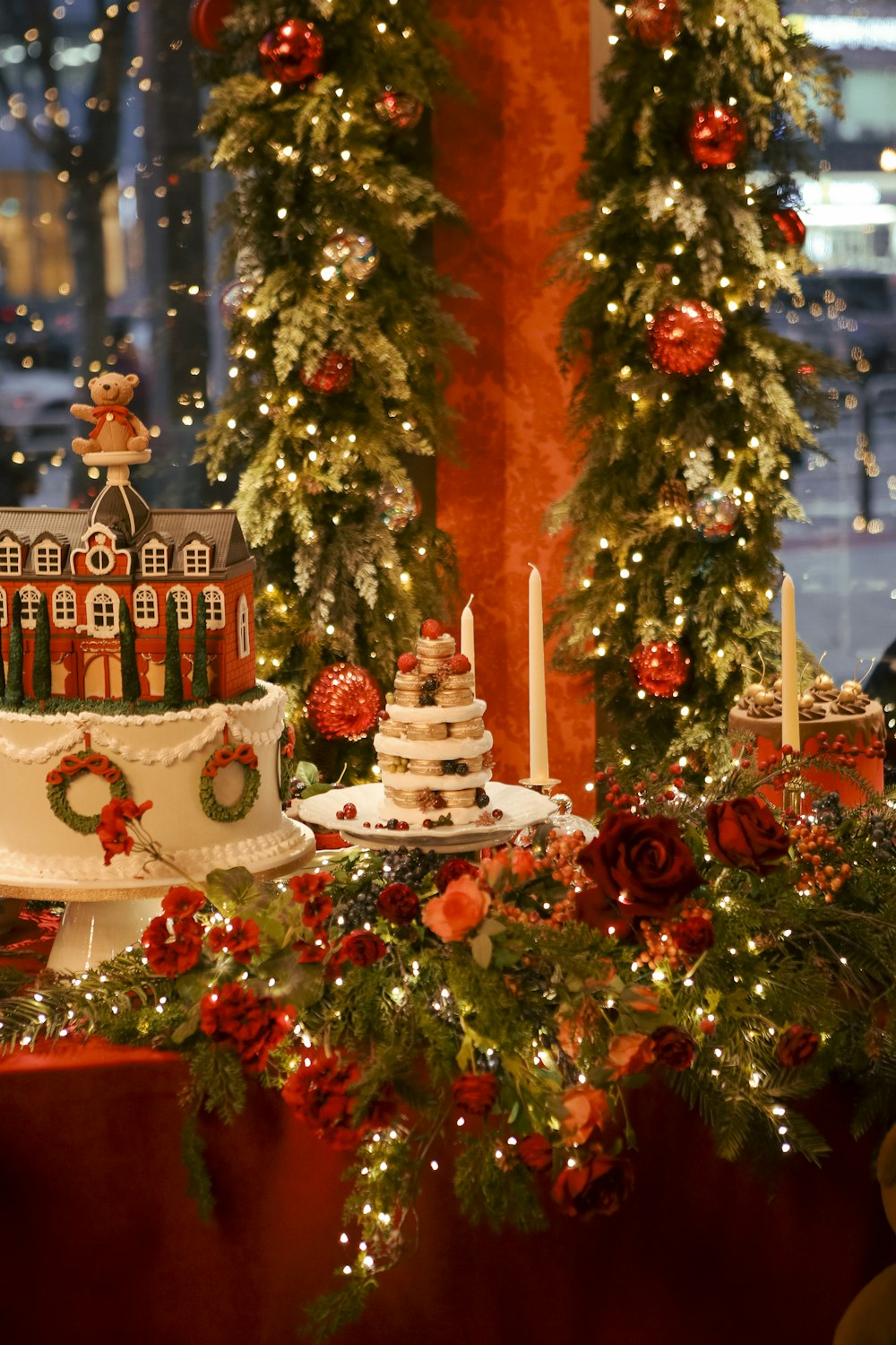 a christmas themed cake on a table in front of a christmas tree