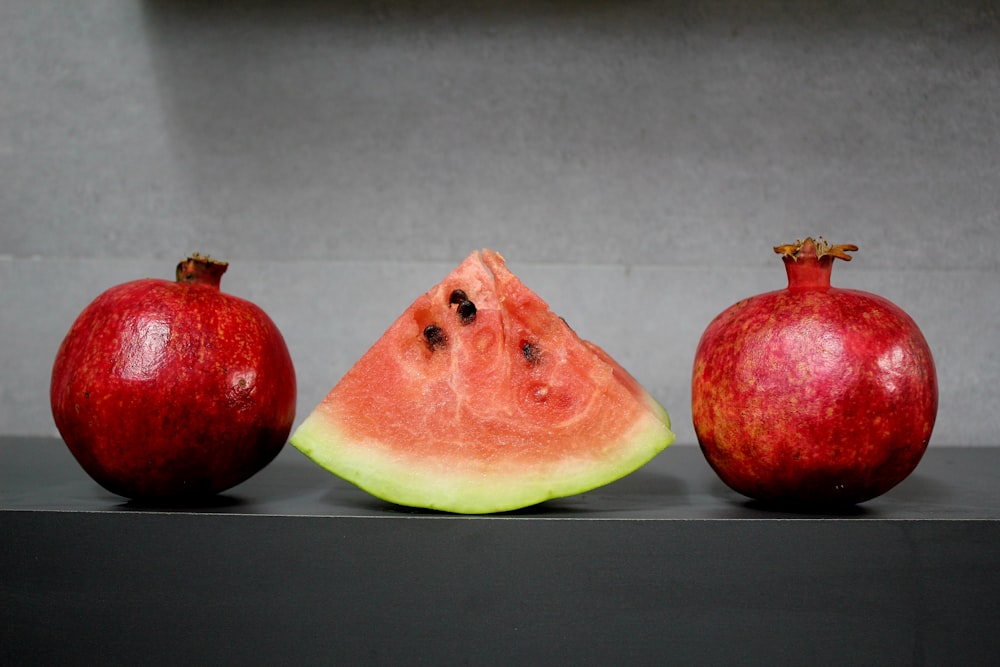 three pieces of a watermelon and two pieces of an apple