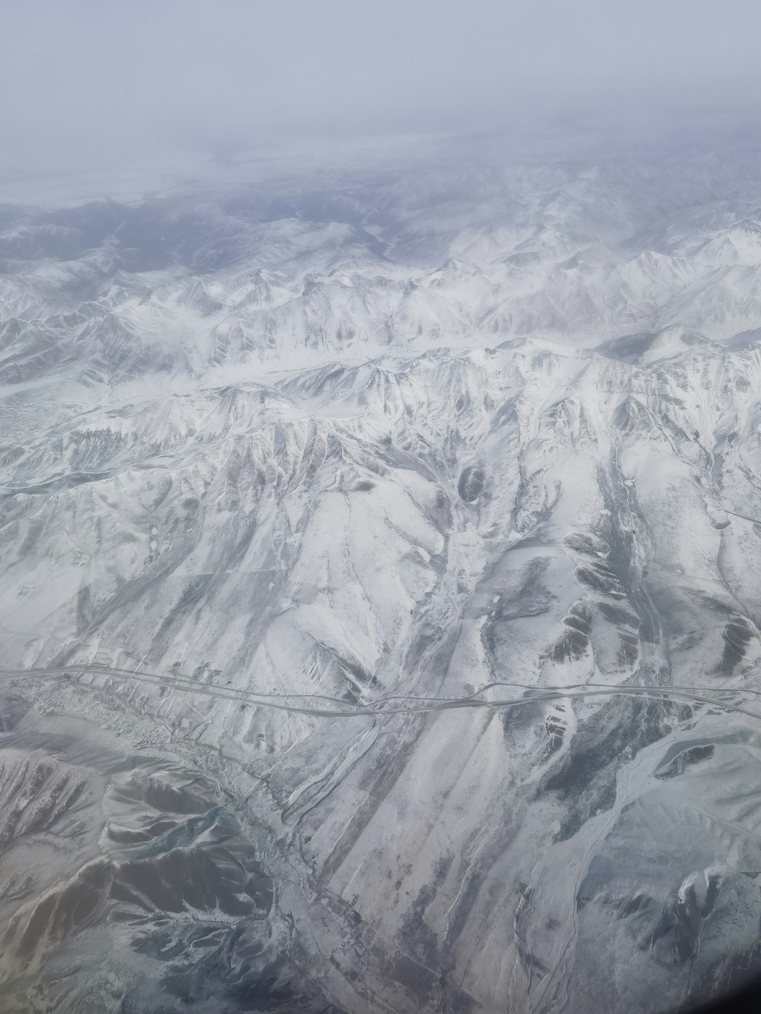 a view of a mountain range from an airplane window