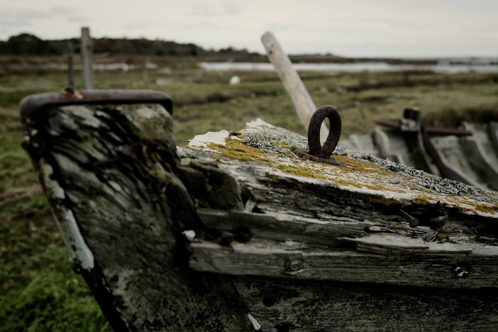 a close up of an old boat in a field