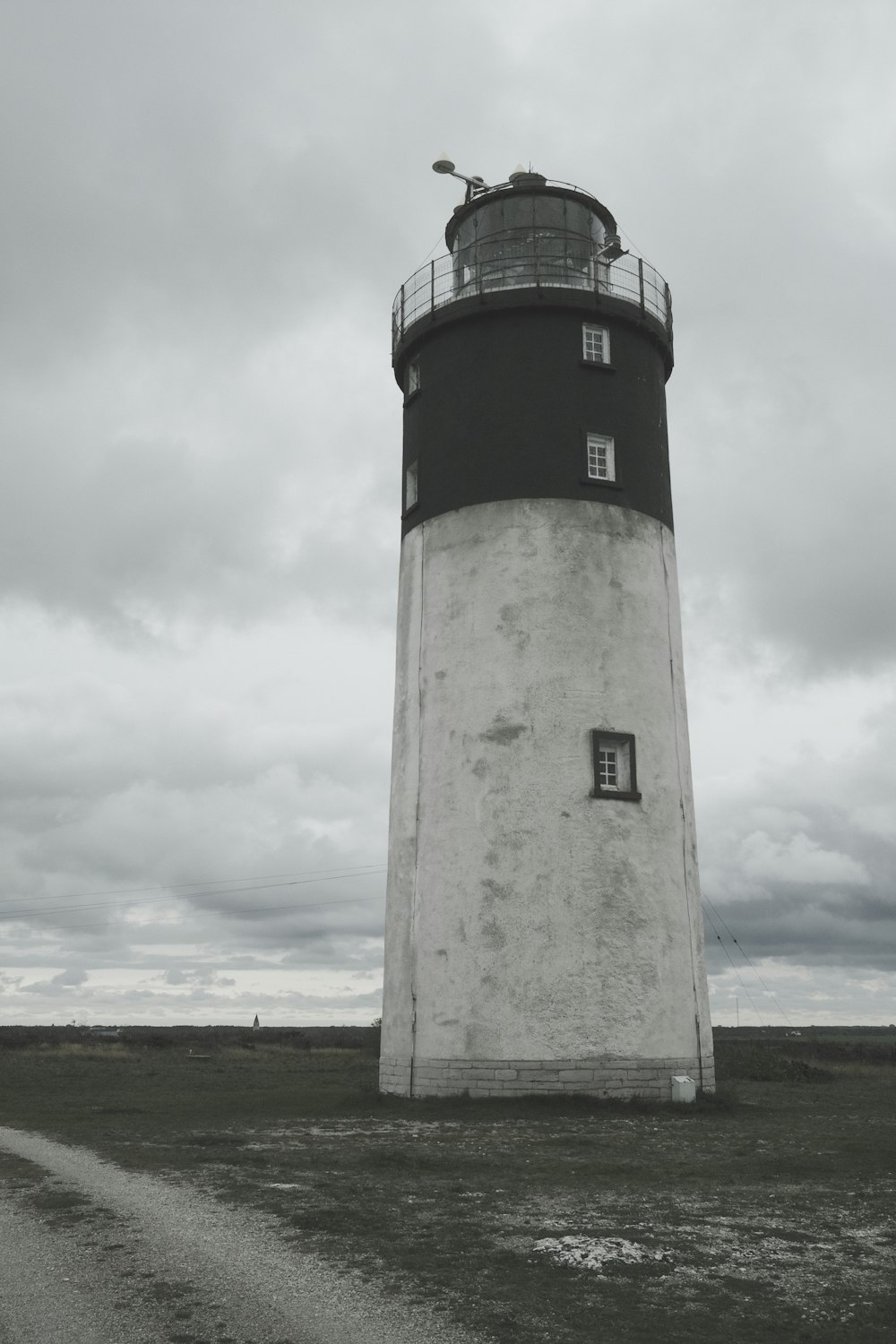 a black and white photo of a lighthouse