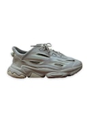 A single athletic sneaker with a chunky sole and intricate design. The shoe features a mix of synthetic materials with mesh inserts for breathability, and a lace-up closure.