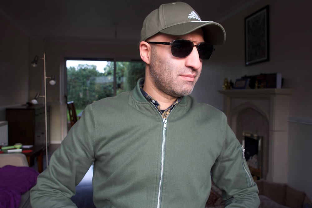 a man wearing a hat and sunglasses in a living room