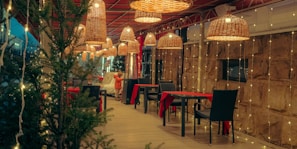 Outdoor dining area at Porche Gurugram Cafe decorated with fairy lights, ideal for evening celebrations