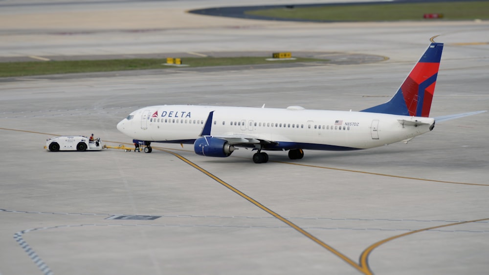a delta airplane is parked on the tarmac