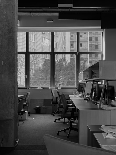 Photo of a Netoxa cleaner professionally tidying an office space in a modern building.