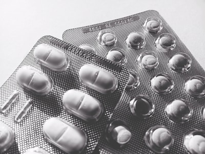 Close-up of a high-quality medicine carton being printed on bleach card stock with vibrant colors.