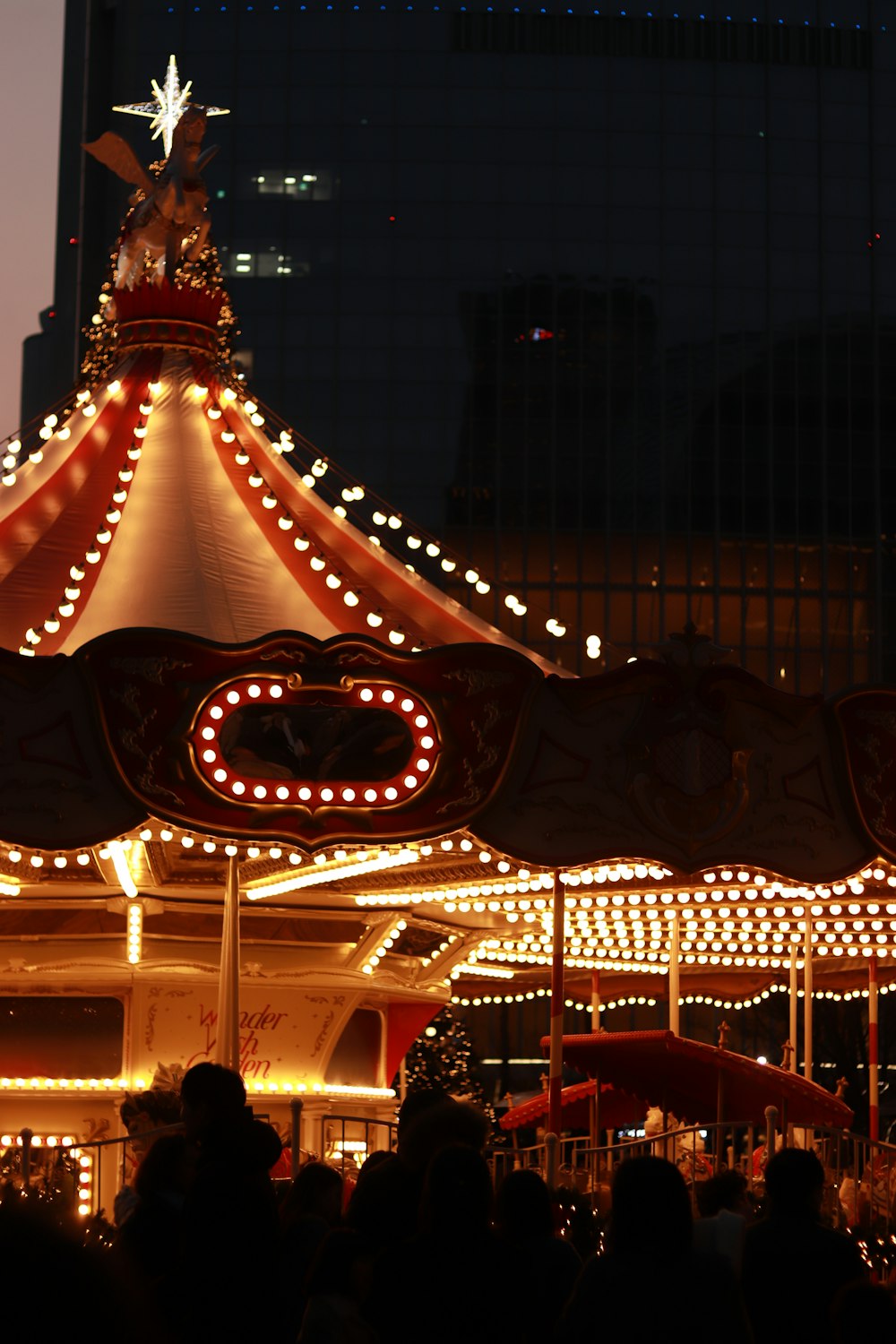 a merry go round at night with lights on it