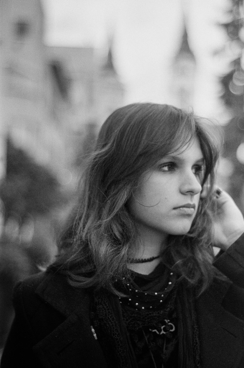 a black and white photo of a woman talking on a cell phone