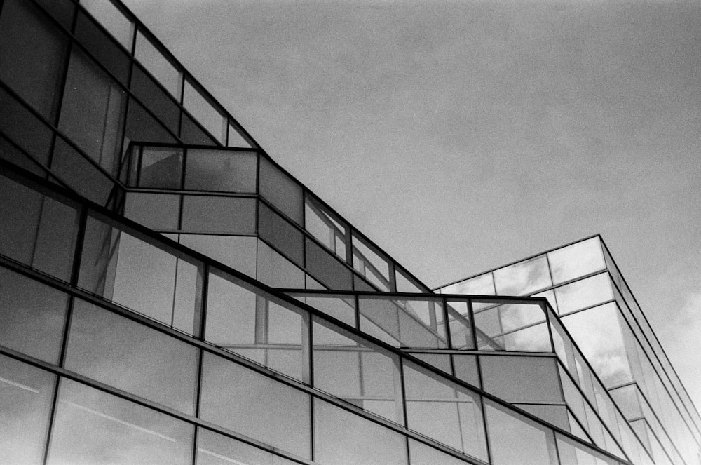 a black and white photo of a glass building