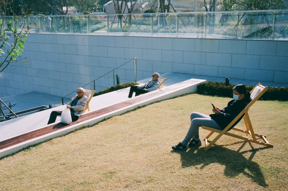 a group of people sitting in lawn chairs