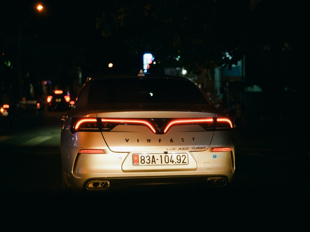 a car parked on the side of the road at night