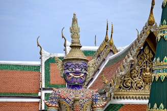 a statue of a person with a purple mask on top of a building
