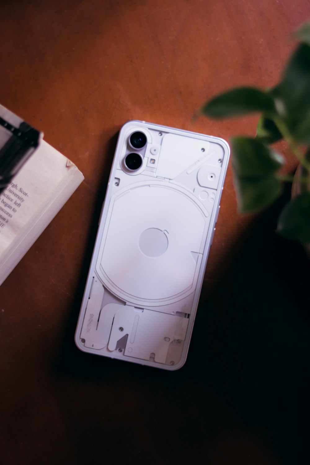 a white ipod sitting on top of a wooden table