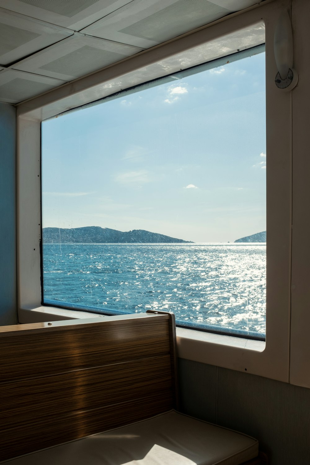 a bench sitting in front of a window on a boat