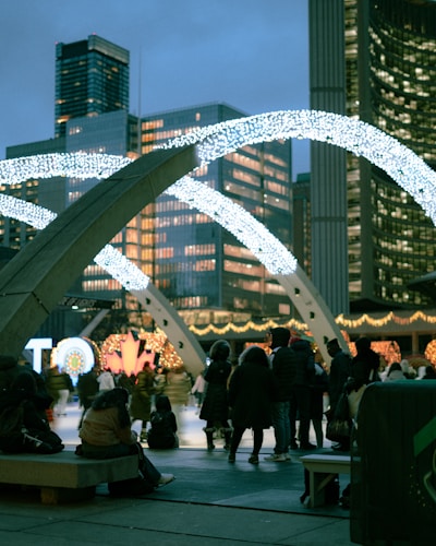A group of holiday lighting enthusiasts gathered around a projector during a lively Light Up Arizona meetup.