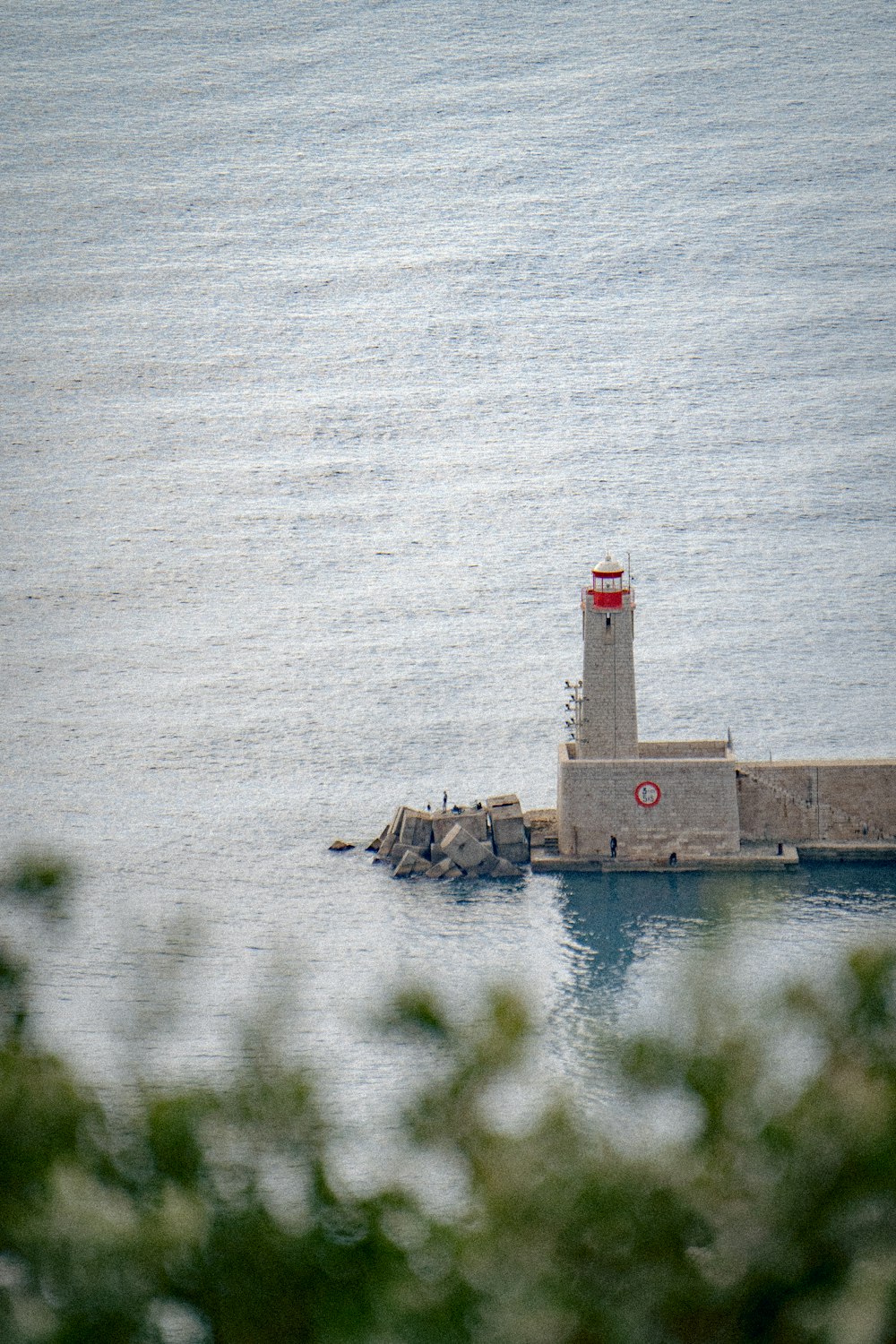 a small light house sitting on top of a pier