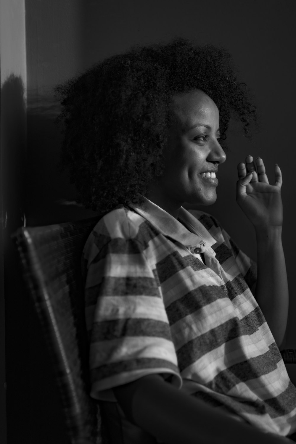 a black and white photo of a woman sitting in a chair