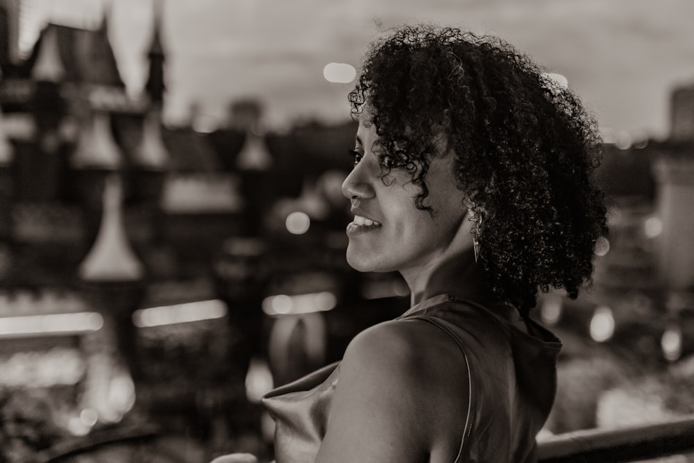 a black and white photo of a woman smiling