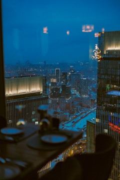 Sophisticated cityscape viewed from a high-level office at dusk.