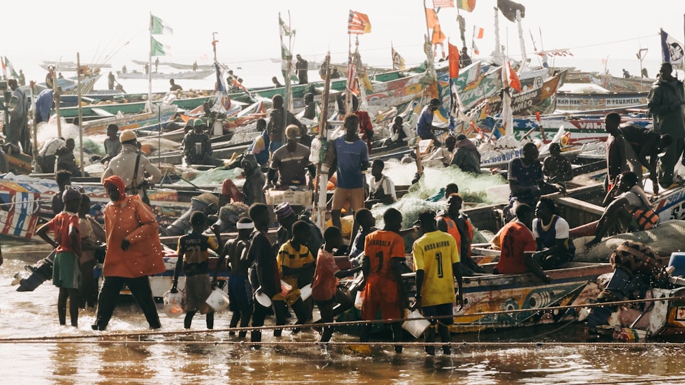 a group of people standing on top of a boat