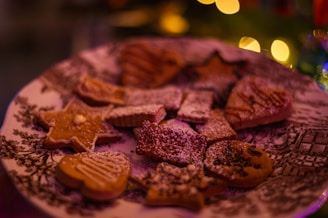 Variety of colorful decorated biscuits arranged on a vintage ceramic plate