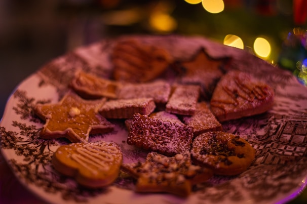 Variety of colorful decorated biscuits arranged on a vintage ceramic plate