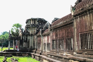 An ancient temple entrance framed by lush greenery and intricate stone carvings