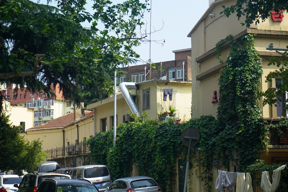 cars parked on the side of the road in front of a building