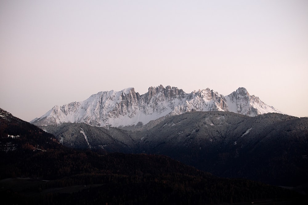 a mountain range with snow covered mountains in the background