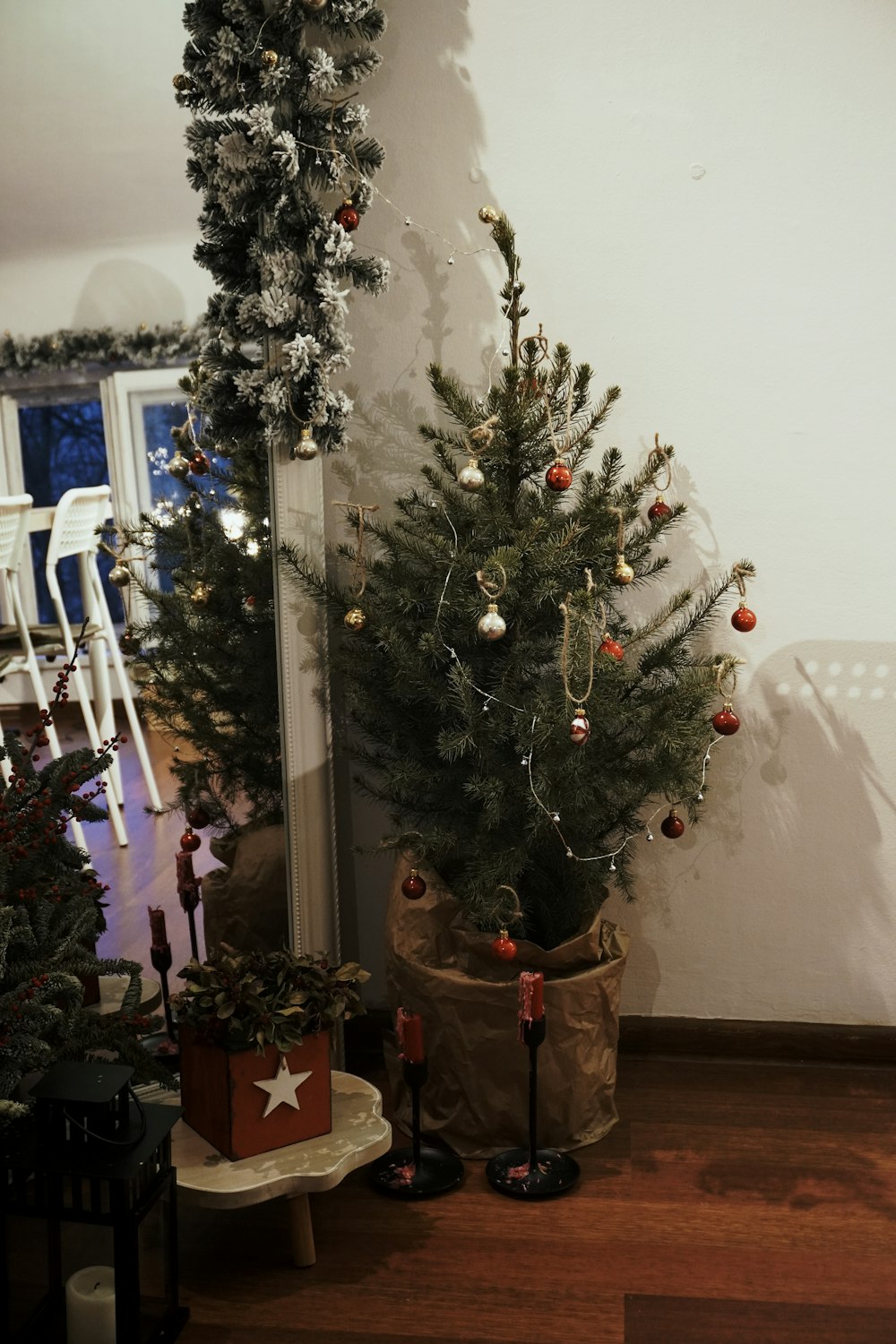 a small christmas tree in a pot on the floor