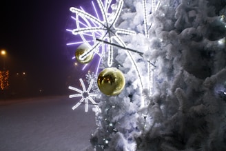 A beautifully decorated Christmas tree surrounded by twinkling lights and snowflakes.