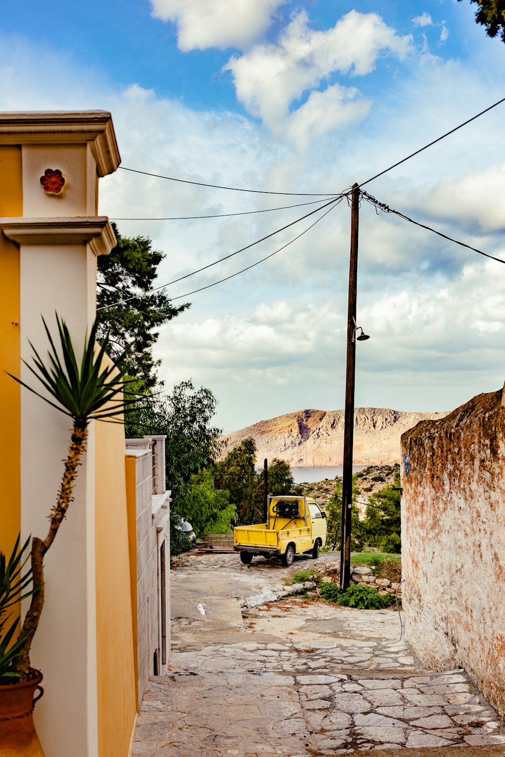 a yellow truck parked on the side of a road