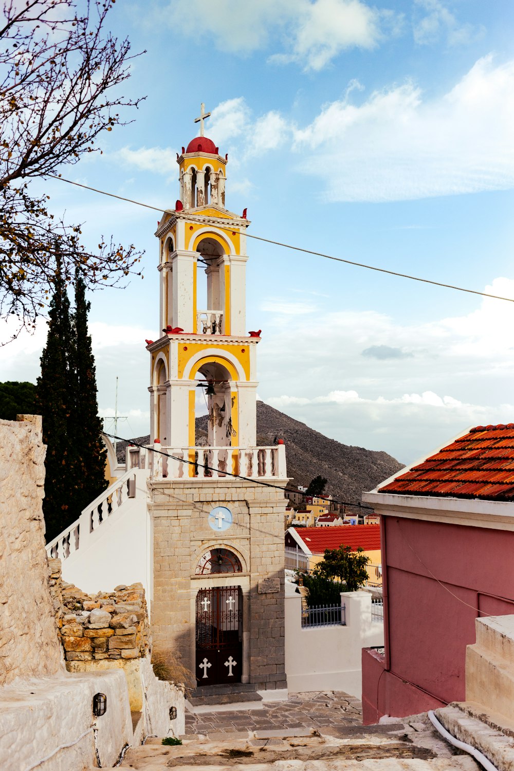 a church with a bell tower in the middle of town