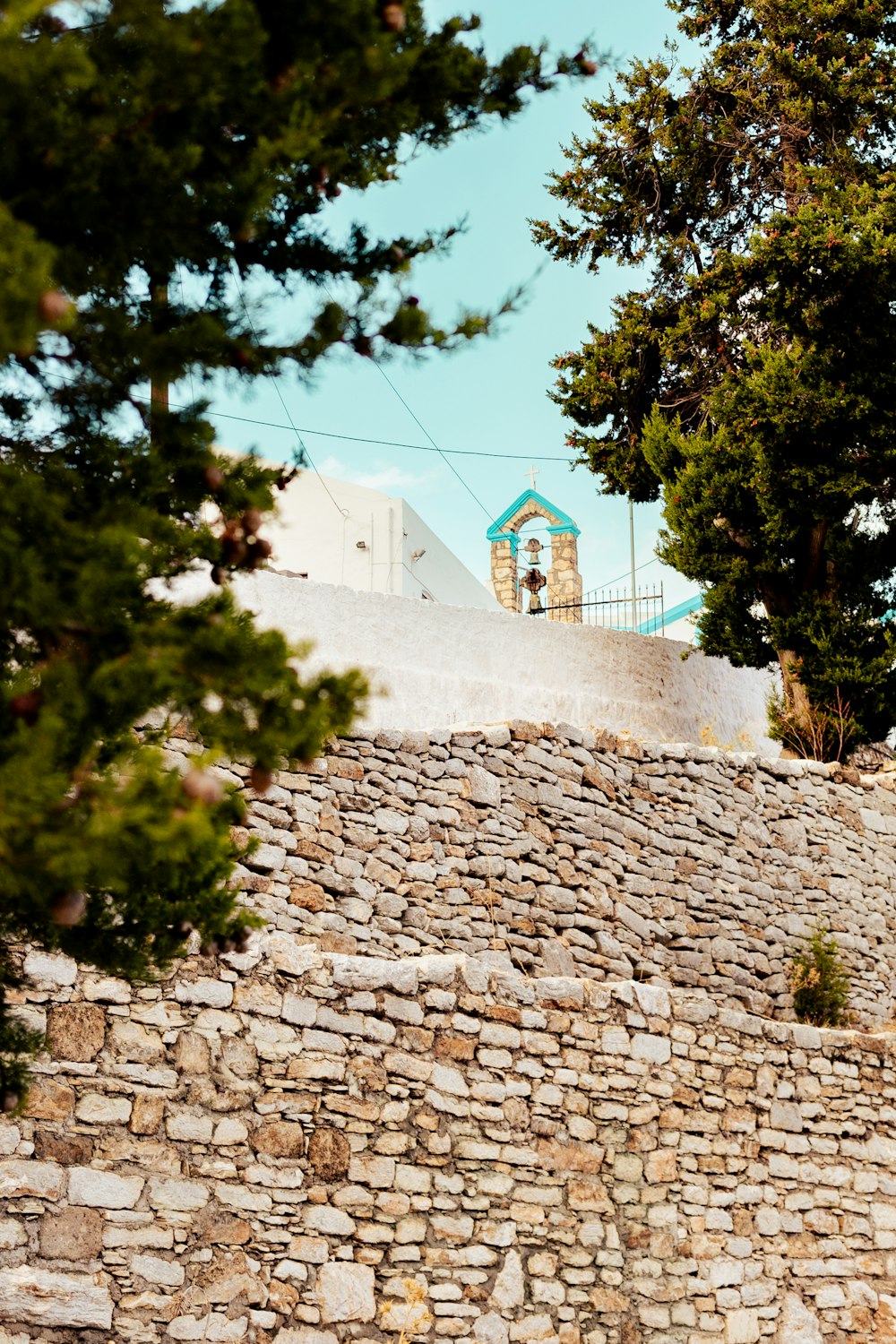 a clock tower on top of a stone wall